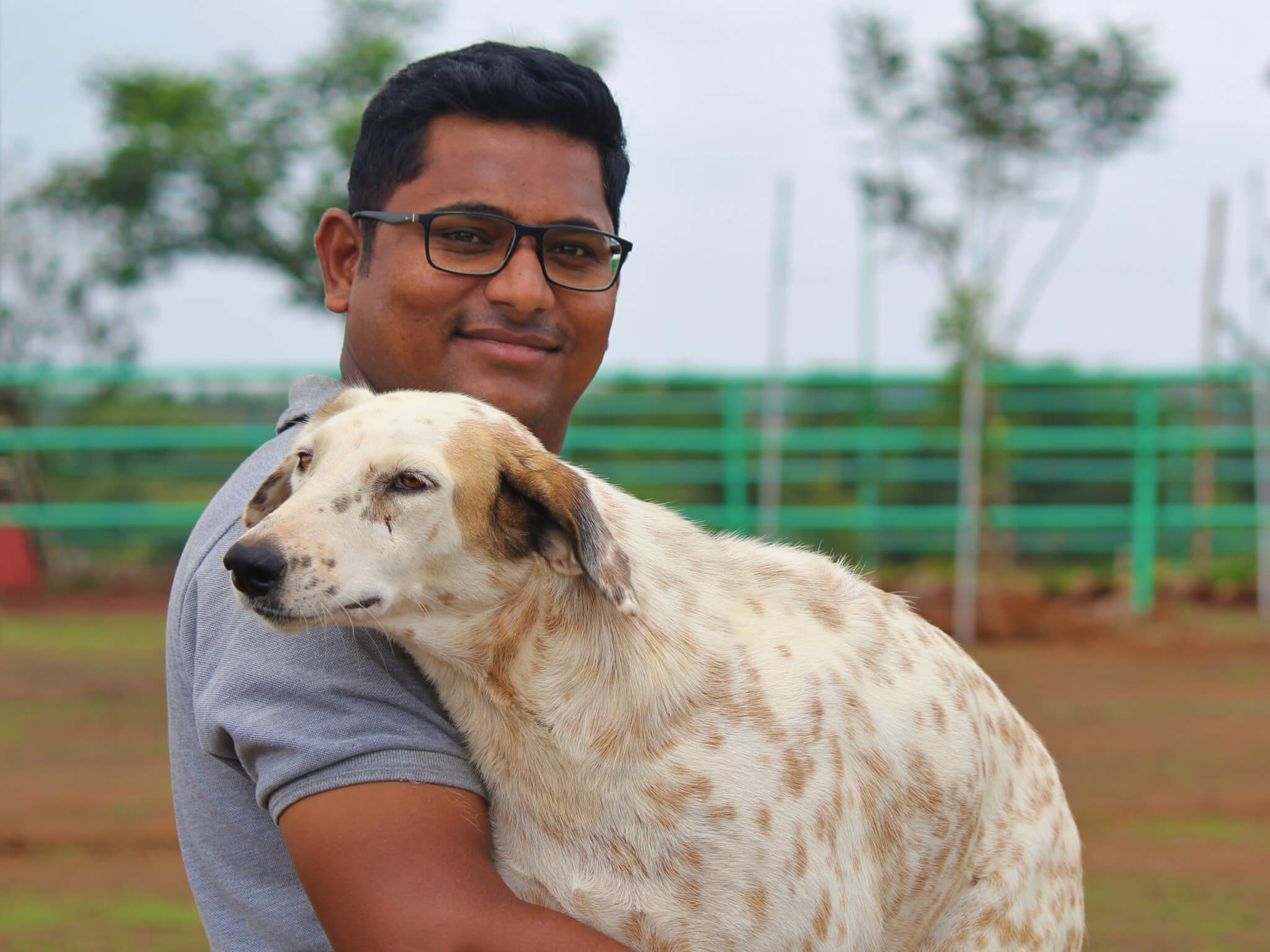 Koustubh Pol holds sanctuary resident Tommy the dog.