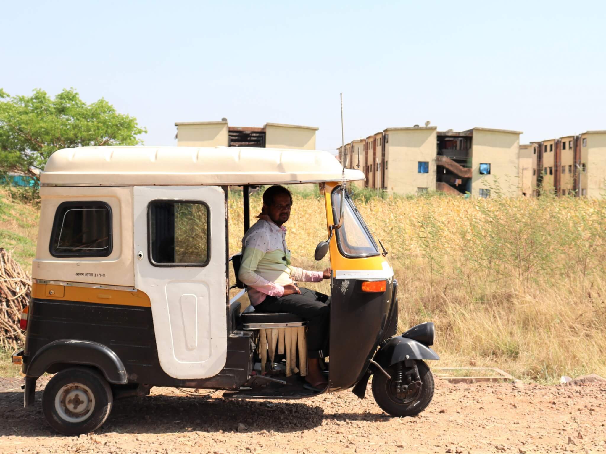 A former tonga driver poses in his auto-rickshaw.