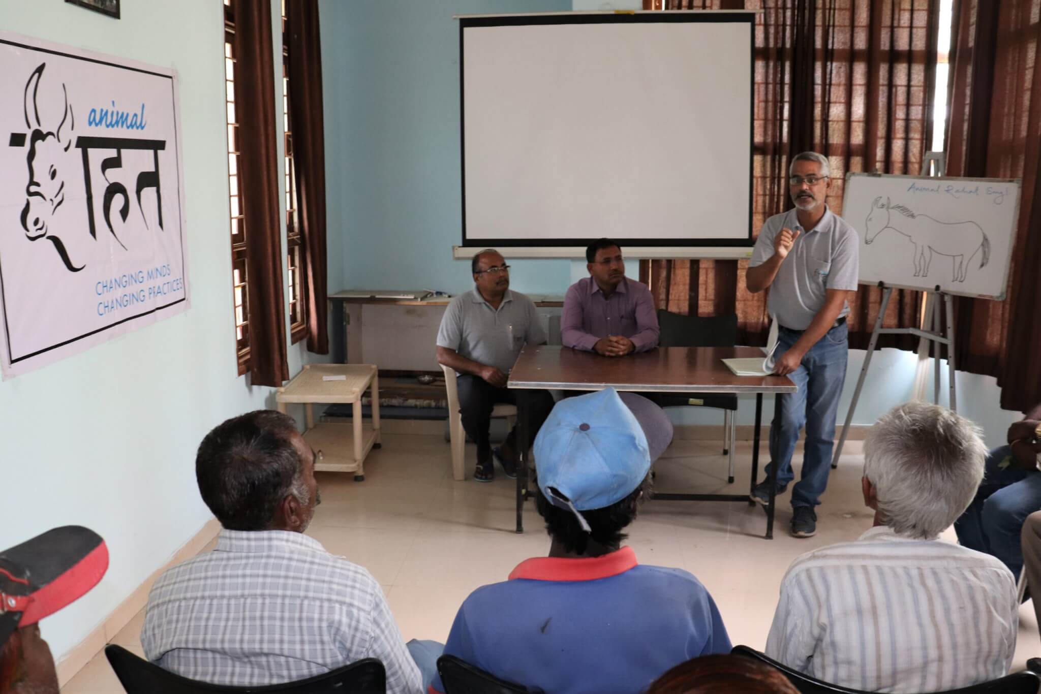 Animal Rahat staffers give a presentation on the importance of mechanizing and how they can help.