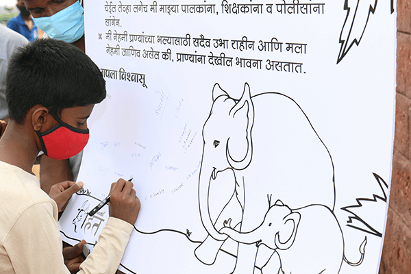 Students sign a pledge to protect animals.