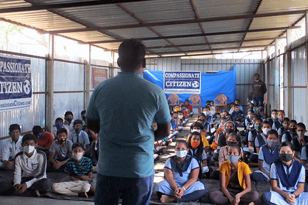 A group of students listen intently at an Animal Rahat Compassionate Citizen humane education workshop.